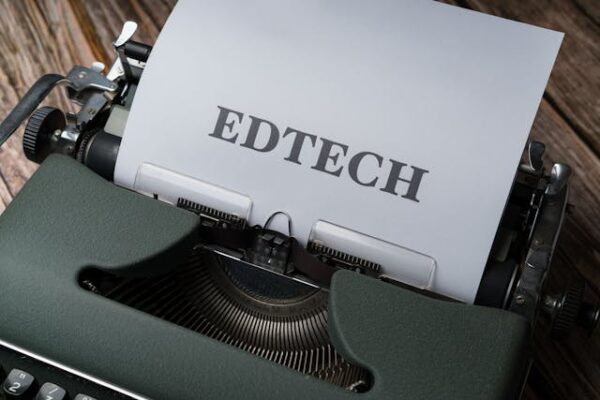 Typewriter with a piece of paper having EdTech written on it. 