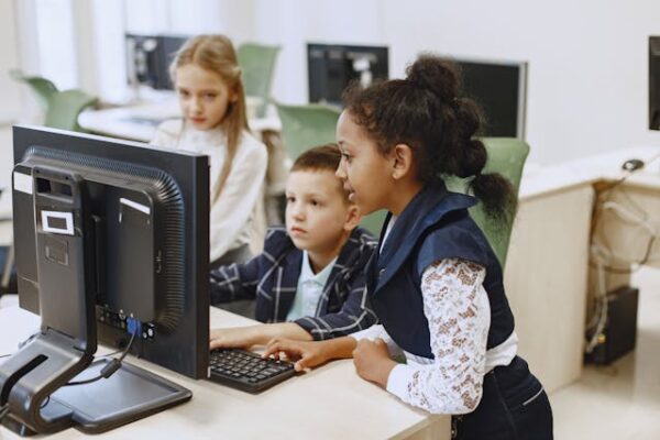 students working on computer in classroom